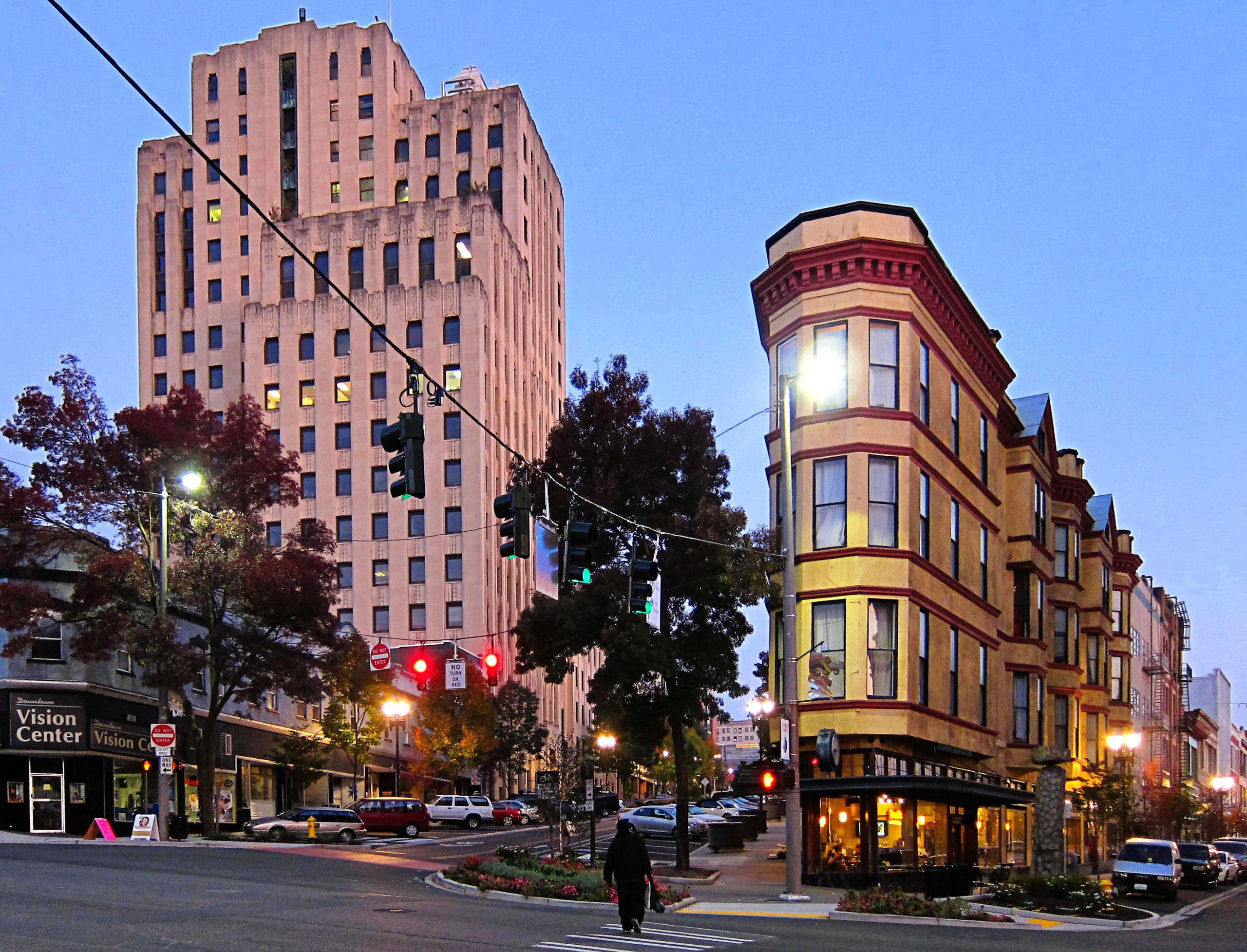 Tall buildings seen at twilight in downtown Tacoma, lit by lights in windows and on the street